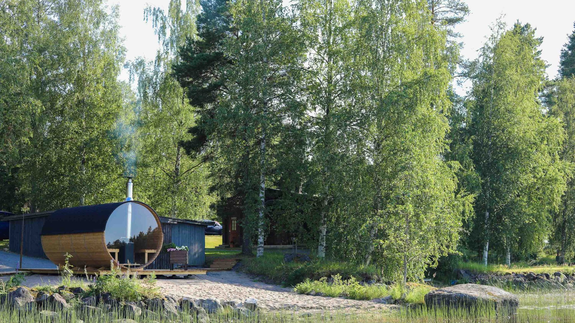 A sauna with lake views is nestled in the trees.