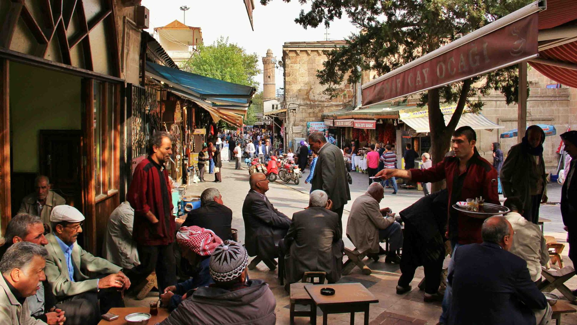 People at a cafe within a town square.