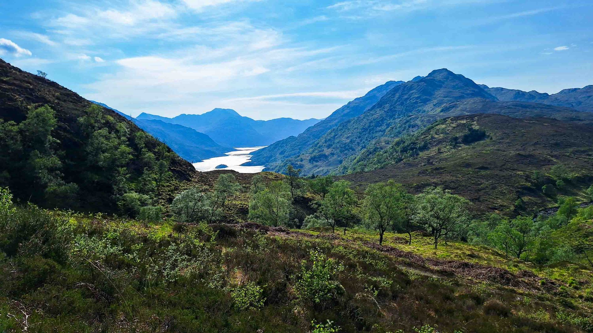 Mountains lead to a lake.