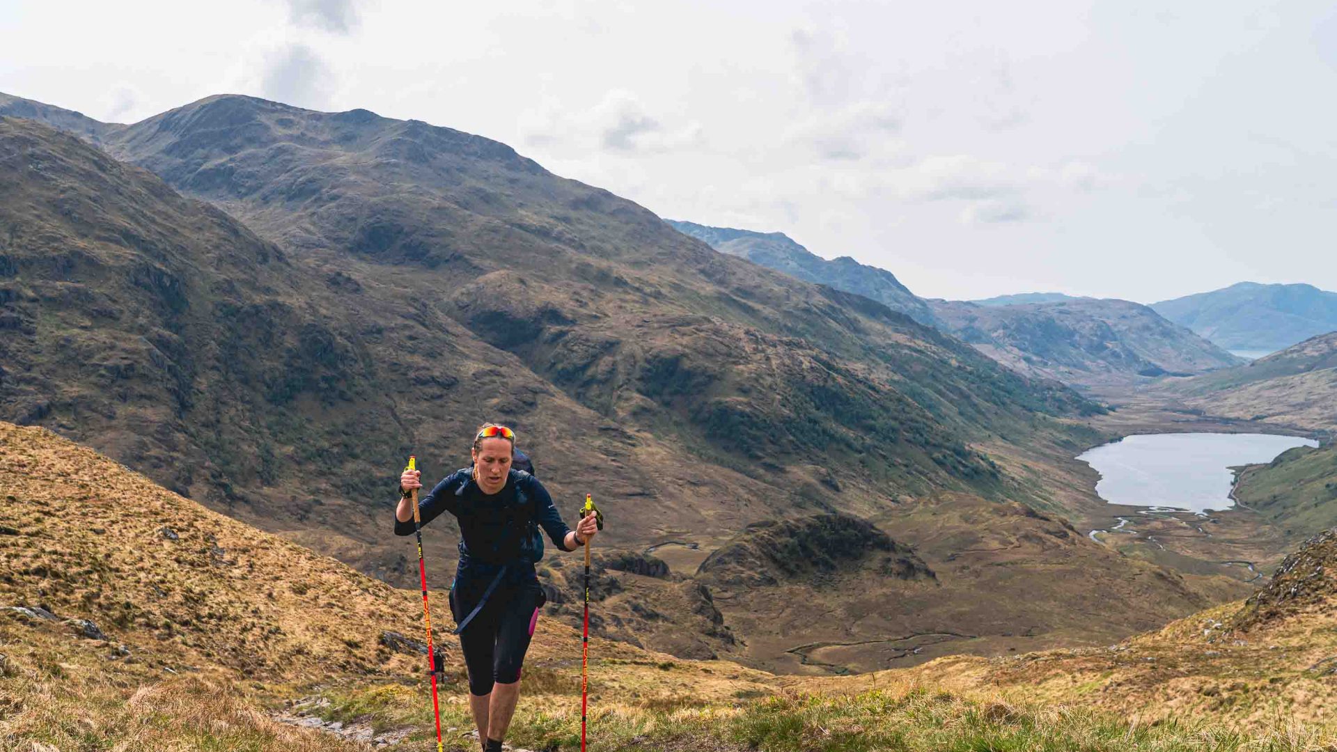 A woman walks up a mountain.