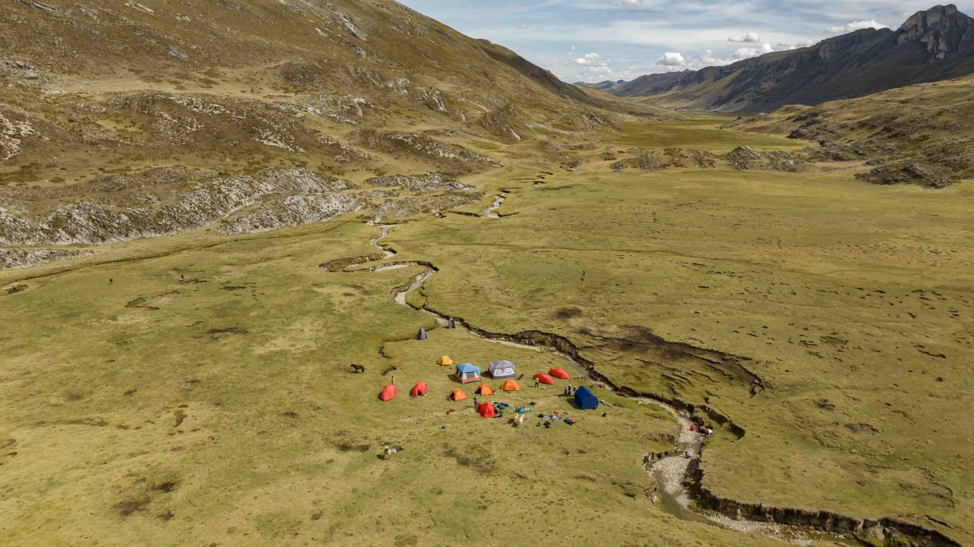 A drone photo of tents in a valley.