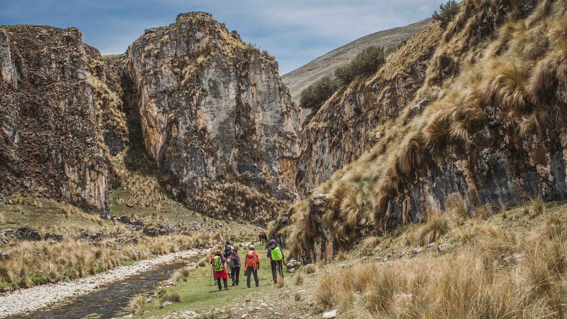 People hike through mountains.